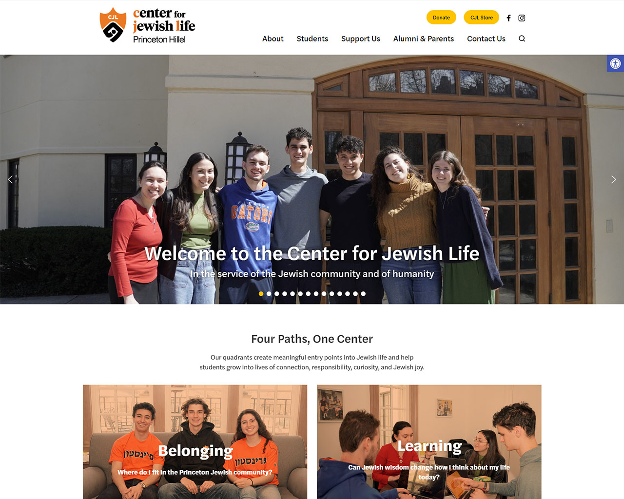 Group of seven smiling students standing arm-in-arm outside a campus building, forming a welcoming banner for the Center for Jewish Life at Princeton Hillel.